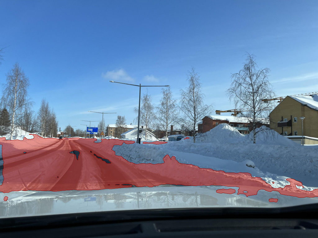 Naive Cityscapes road segmentation applied directly to the snow frame, painting the class across snow and sky.